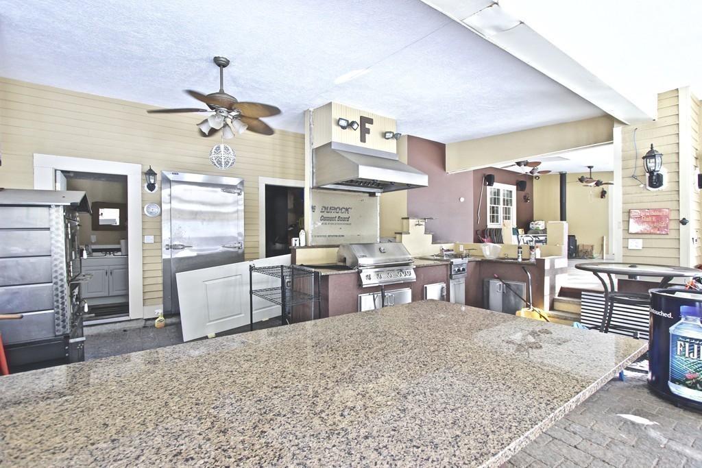 70 Summer Street Stoneham, MA 02180 - Photo 26 of 30 a large kitchen with a table and chairs in it