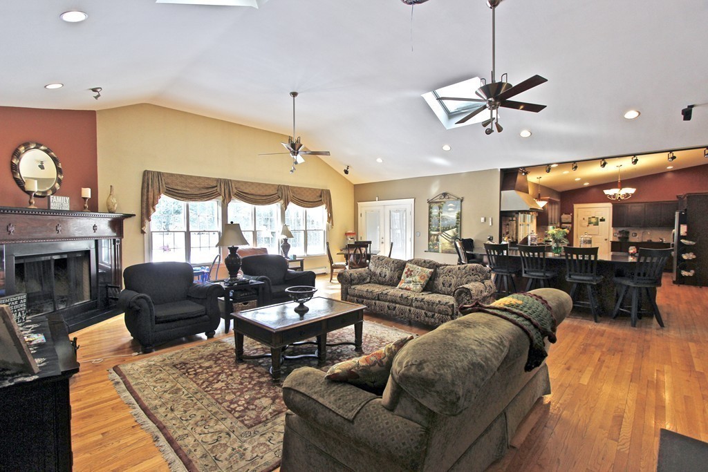 70 Summer Street Stoneham, MA 02180 - Photo 5 of 30 a living room with furniture a fireplace and a chandelier
