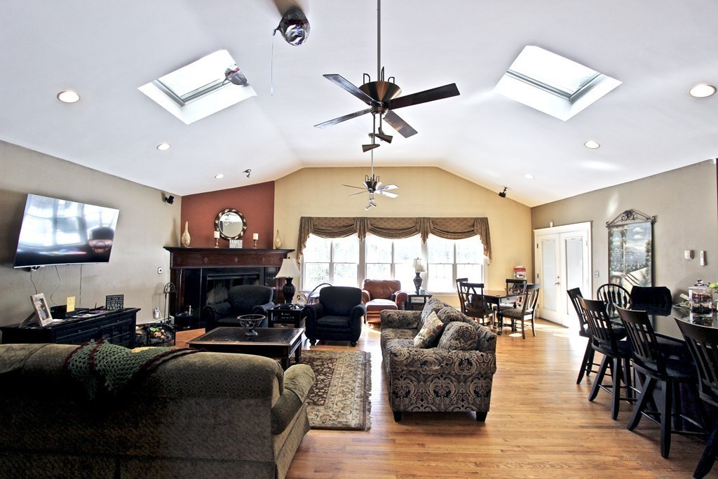 70 Summer Street Stoneham, MA 02180 - Photo 6 of 30 a living room with furniture a fireplace and a flat screen tv