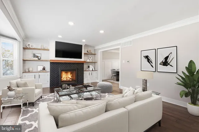 a living room with furniture a fireplace and a flat screen tv