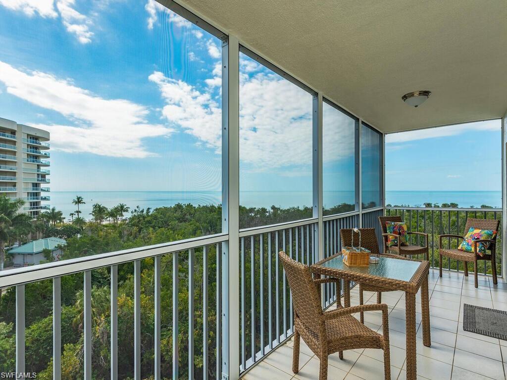 1 Bluebill Avenue, Unit 709 Naples, FL 34108 - Photo 1 of 30 a view of a chairs and table in the balcony