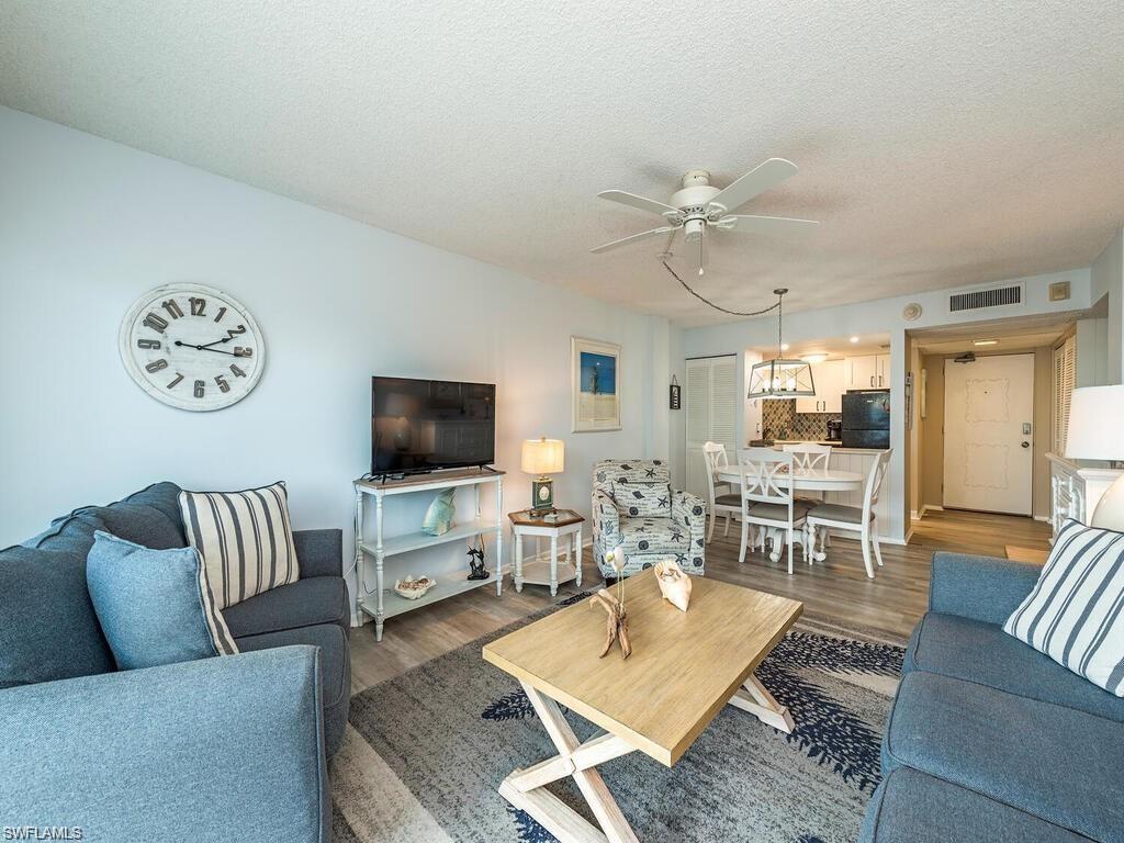 1 Bluebill Avenue, Unit 709 Naples, FL 34108 - Photo 2 of 30 a living room with furniture and a flat screen tv