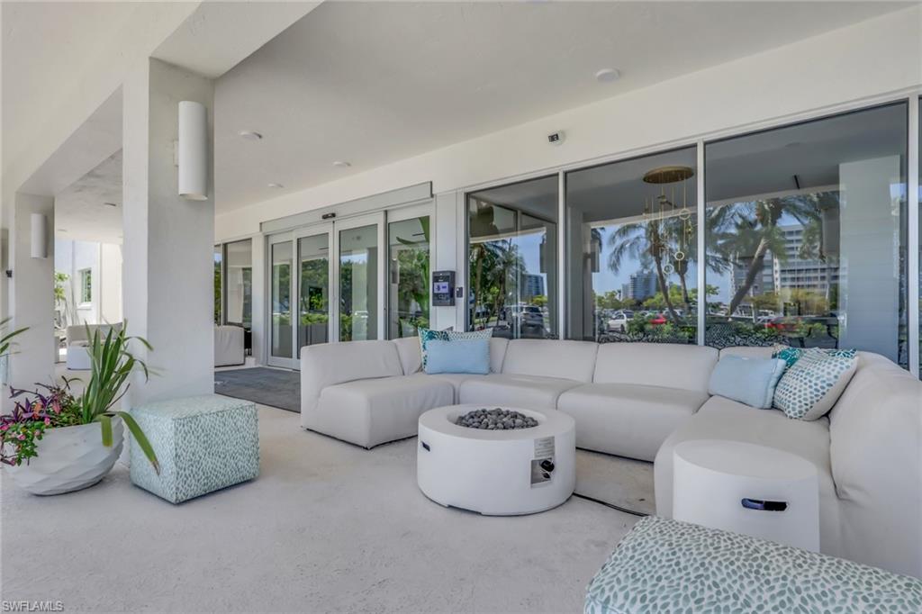 1 Bluebill Avenue, Unit 709 Naples, FL 34108 - Photo 27 of 30 a living room with furniture and a large window