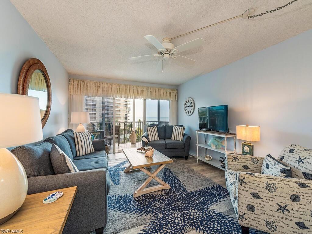1 Bluebill Avenue, Unit 709 Naples, FL 34108 - Photo 3 of 30 a living room with furniture or couch and a flat screen tv