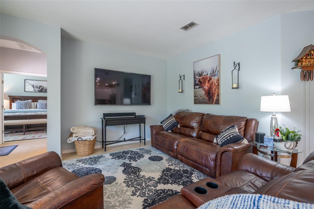 309 Royal Bonnet Drive Apollo Beach, FL 33572 - Photo 12 of 59 a living room with furniture and a flat screen tv