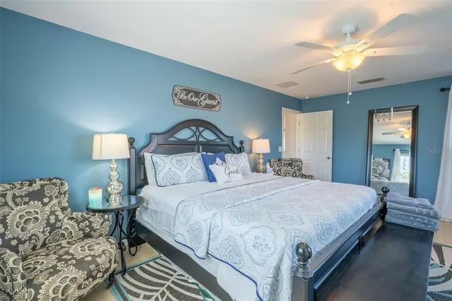 a bathroom with a granite countertop sink mirror toilet and bathtub