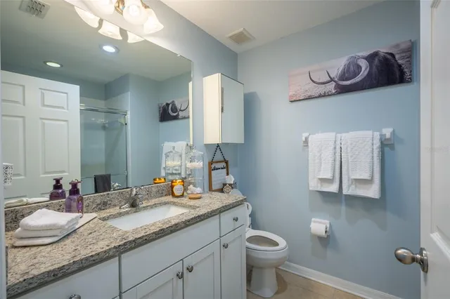 a bedroom with a bed and a table in it with window