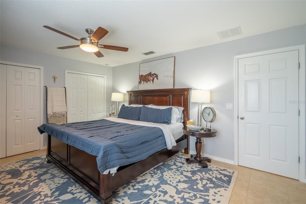 309 Royal Bonnet Drive Apollo Beach, FL 33572 - Photo 30 of 59 a bedroom with a bed and a chandelier