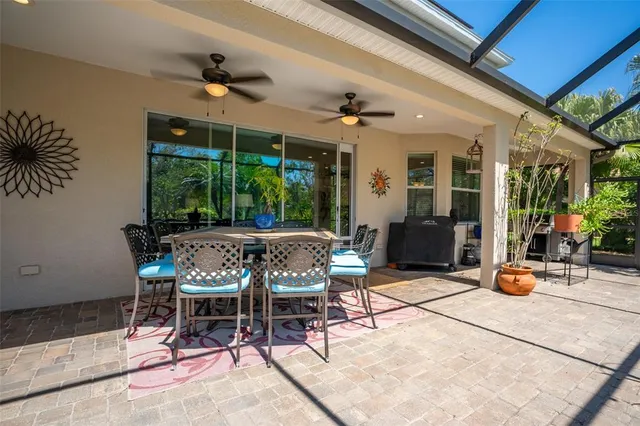 a view of a house with plants and sitting area