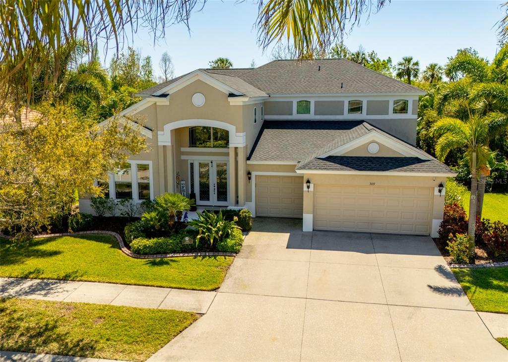 309 Royal Bonnet Drive Apollo Beach, FL 33572 - Photo 43 of 59 a front view of a house with a garden