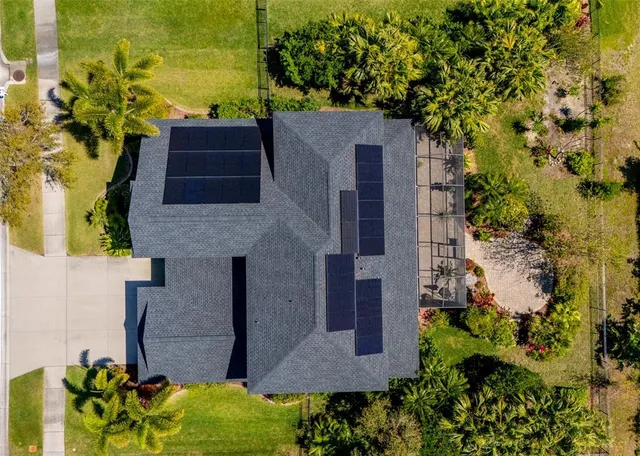 an aerial view of a house with a yard and garden