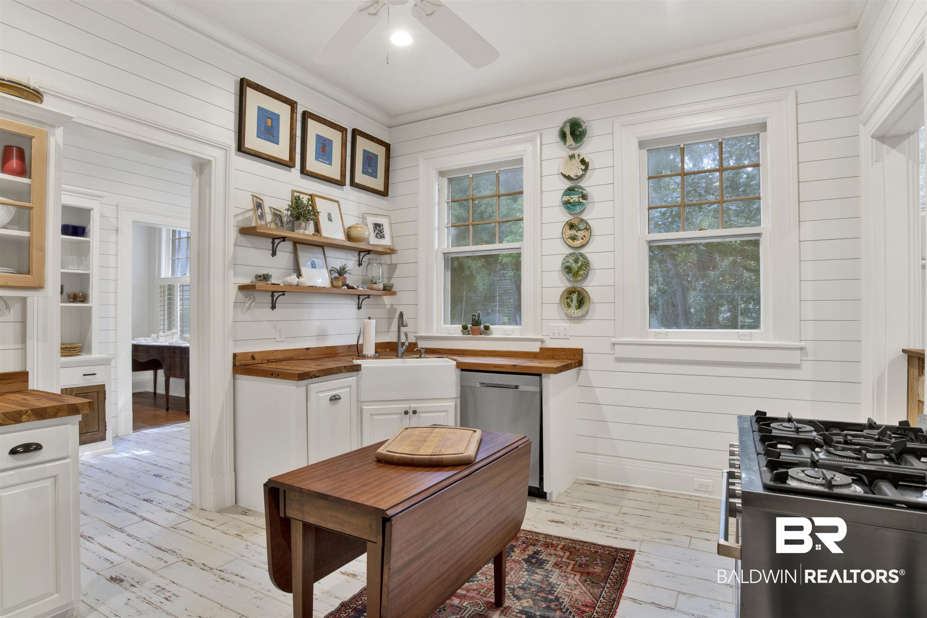 1654 Government Street Mobile, AL 36604 - Photo 28 of 45 Kitchen featuring sink, white cabinetry, butcher block countertops, and light hardwood / wood-style flooring