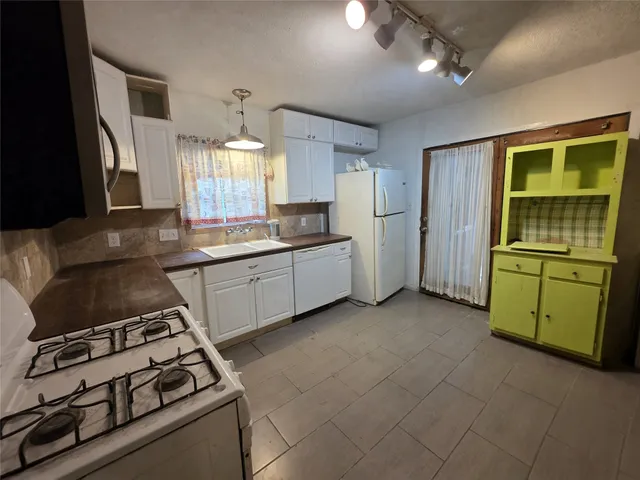 a kitchen that has a sink and a stove