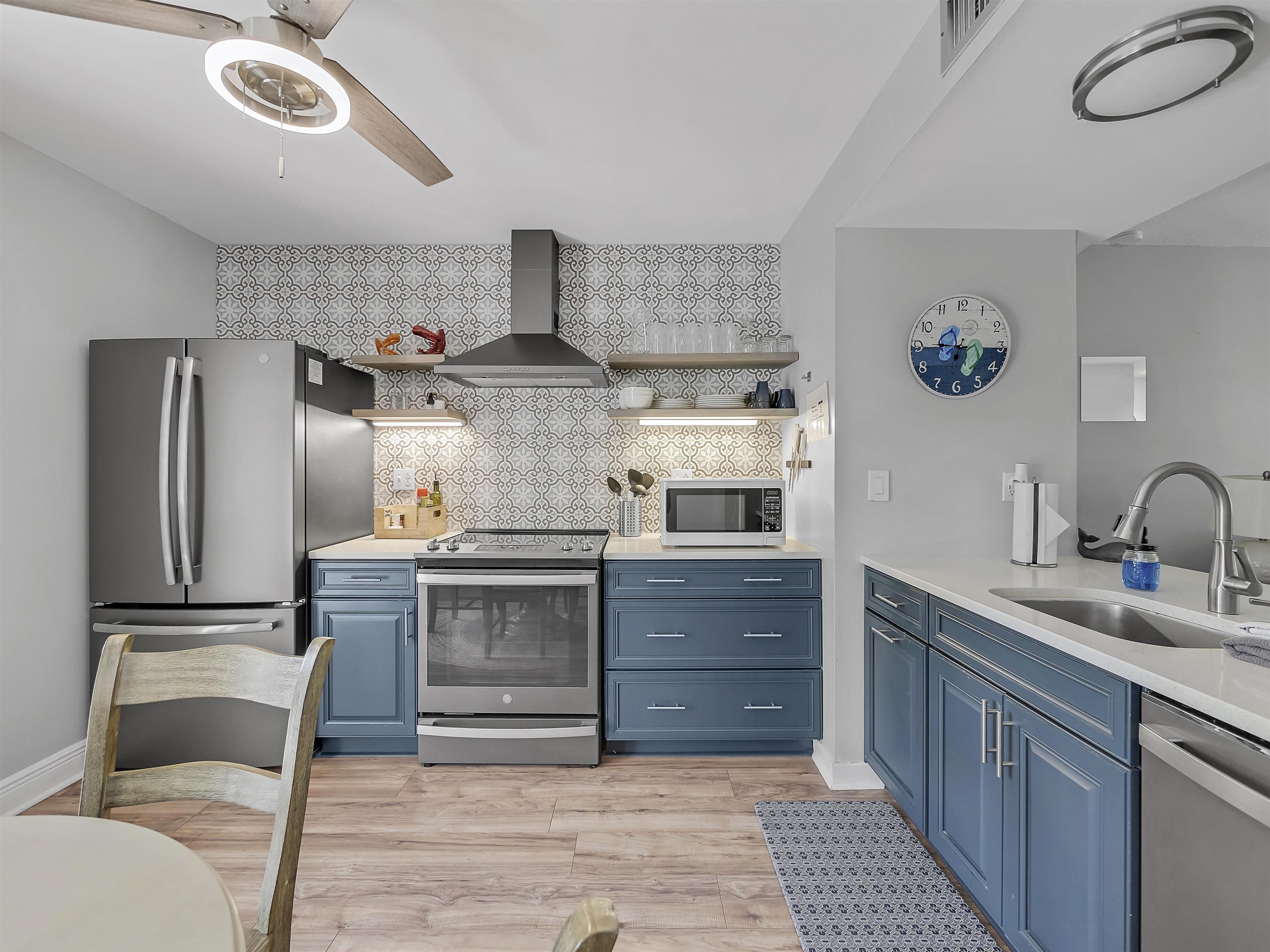 6444 Madison Street St. Augustine, FL 32080 - Photo 13 of 36 a kitchen with stainless steel appliances granite countertop a sink and a refrigerator