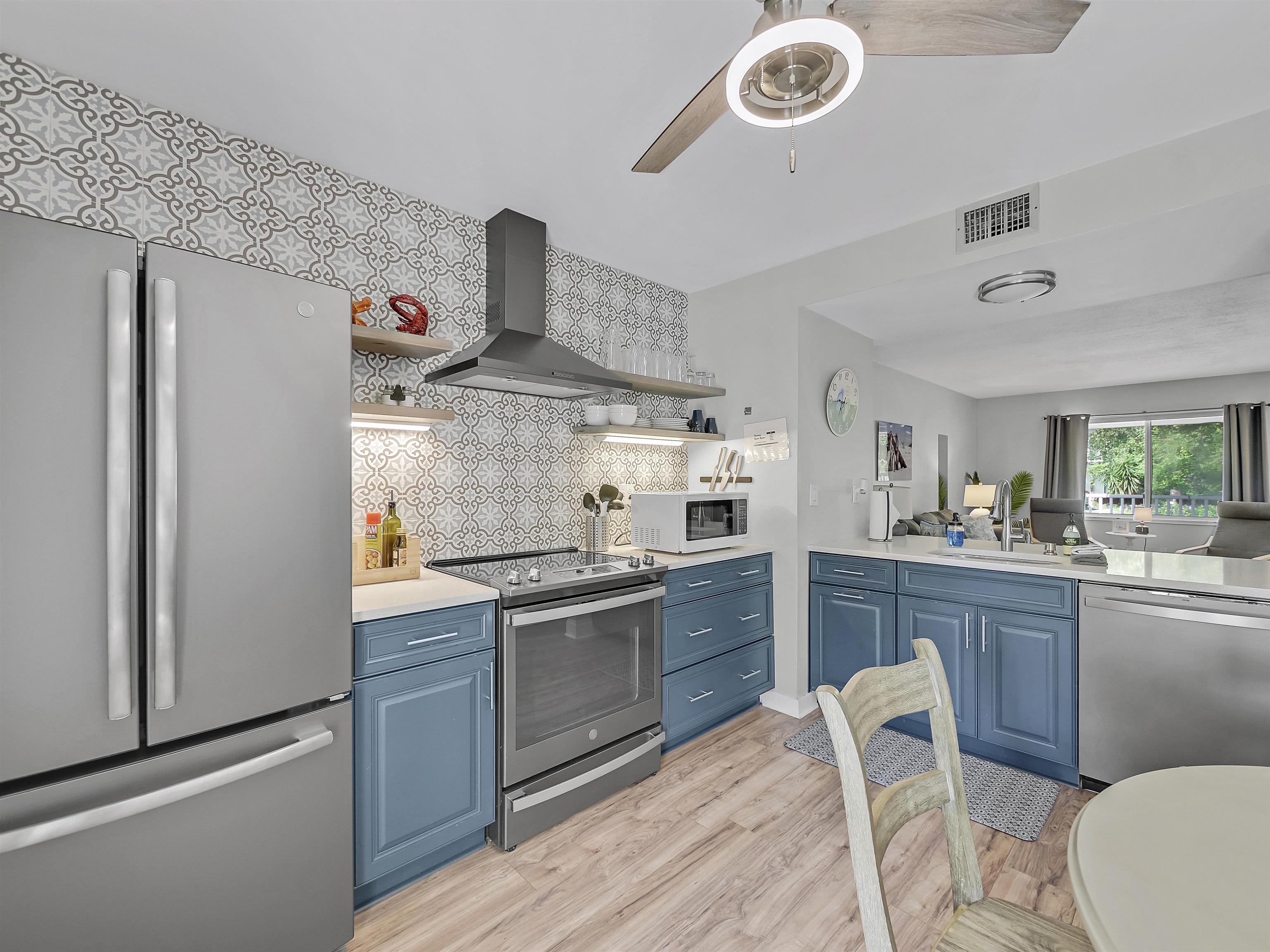 6444 Madison Street St. Augustine, FL 32080 - Photo 15 of 36 a kitchen with granite countertop a sink stainless steel appliances and cabinets