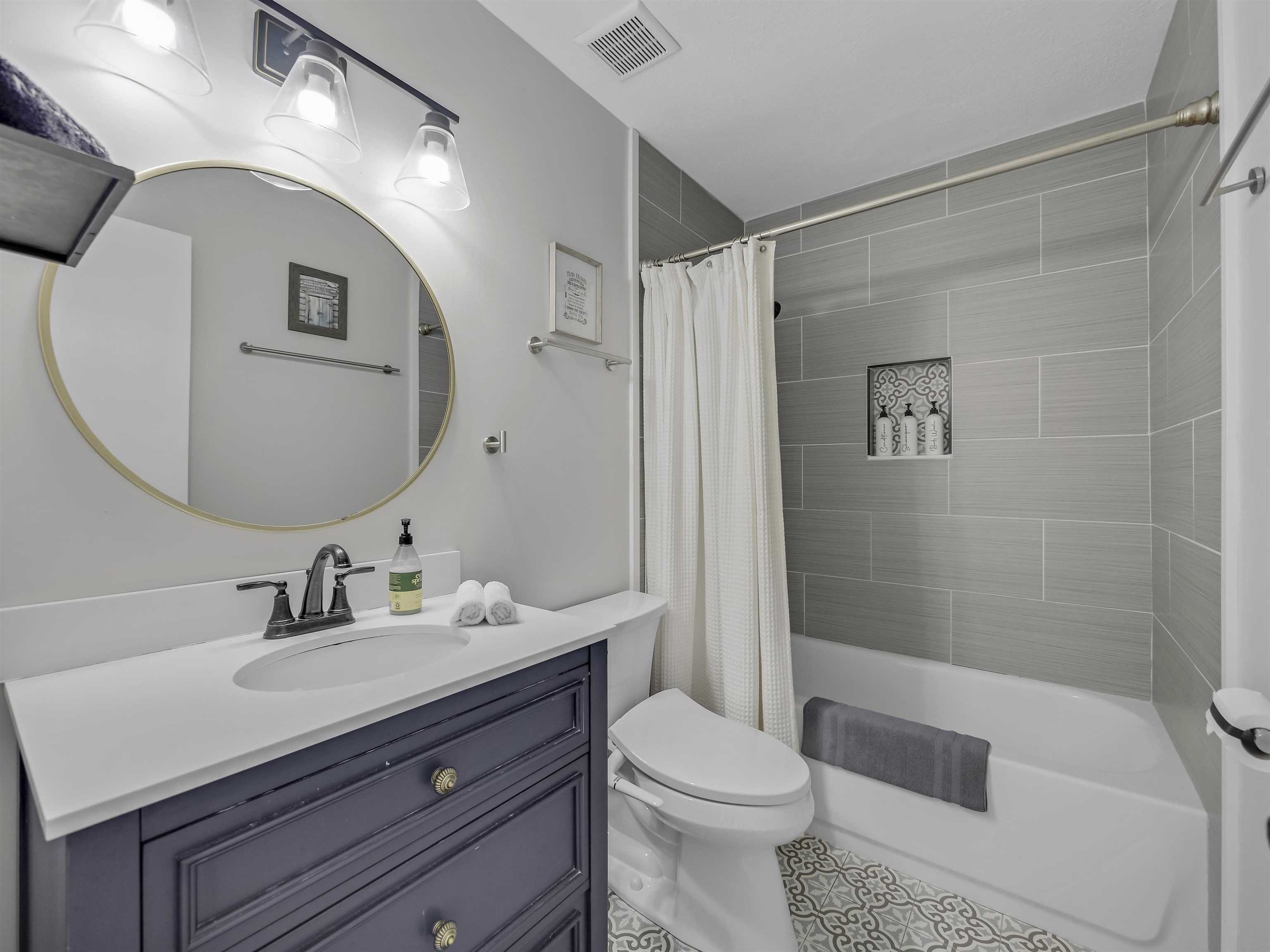 6444 Madison Street St. Augustine, FL 32080 - Photo 25 of 36 a bathroom with a sink a toilet and shower