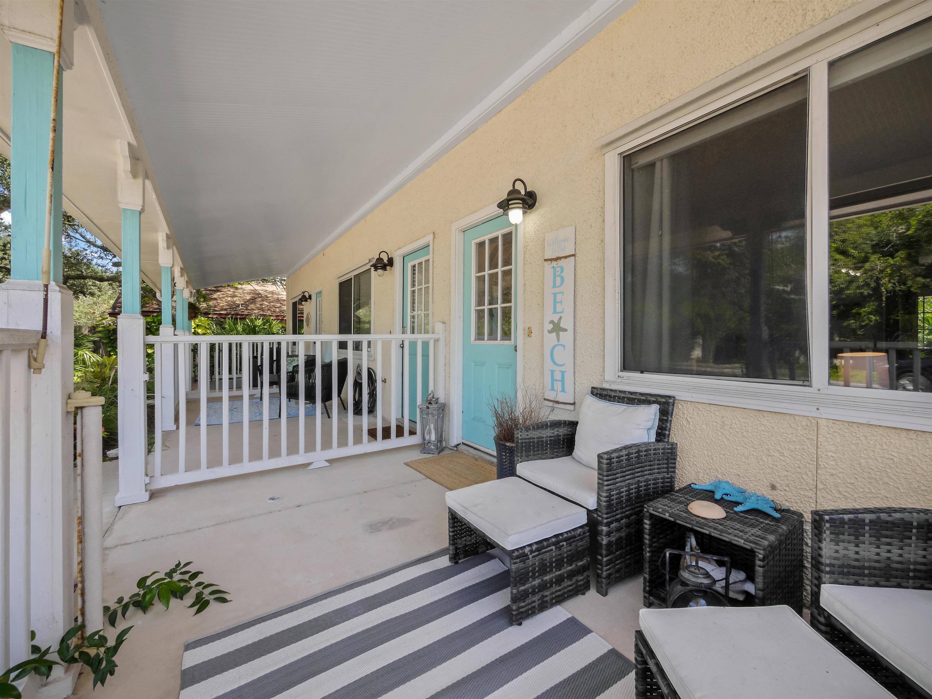 6444 Madison Street St. Augustine, FL 32080 - Photo 7 of 36 a balcony with couple of chairs and a potted plant