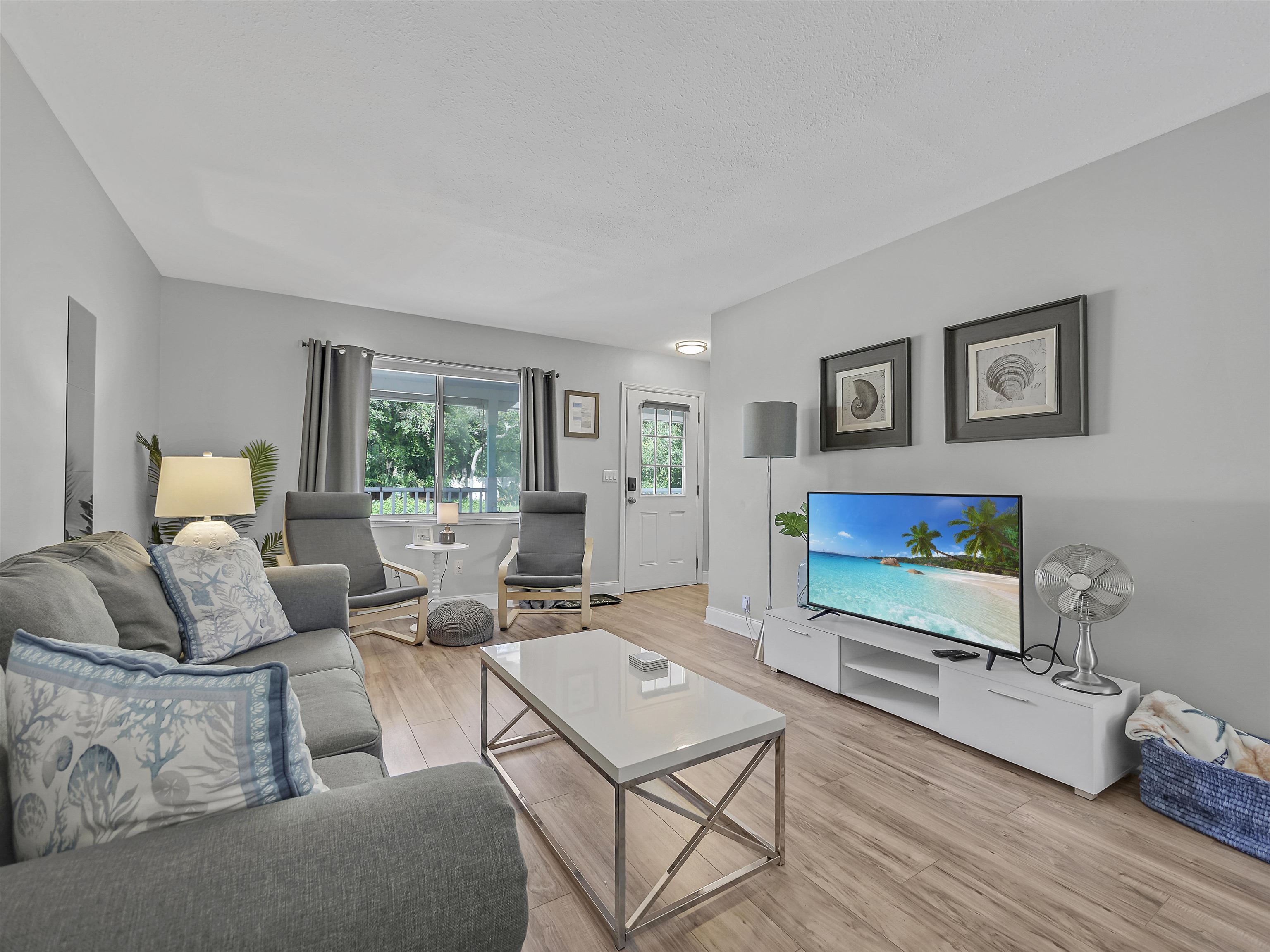6444 Madison Street St. Augustine, FL 32080 - Photo 9 of 36 a living room with furniture and a flat screen tv