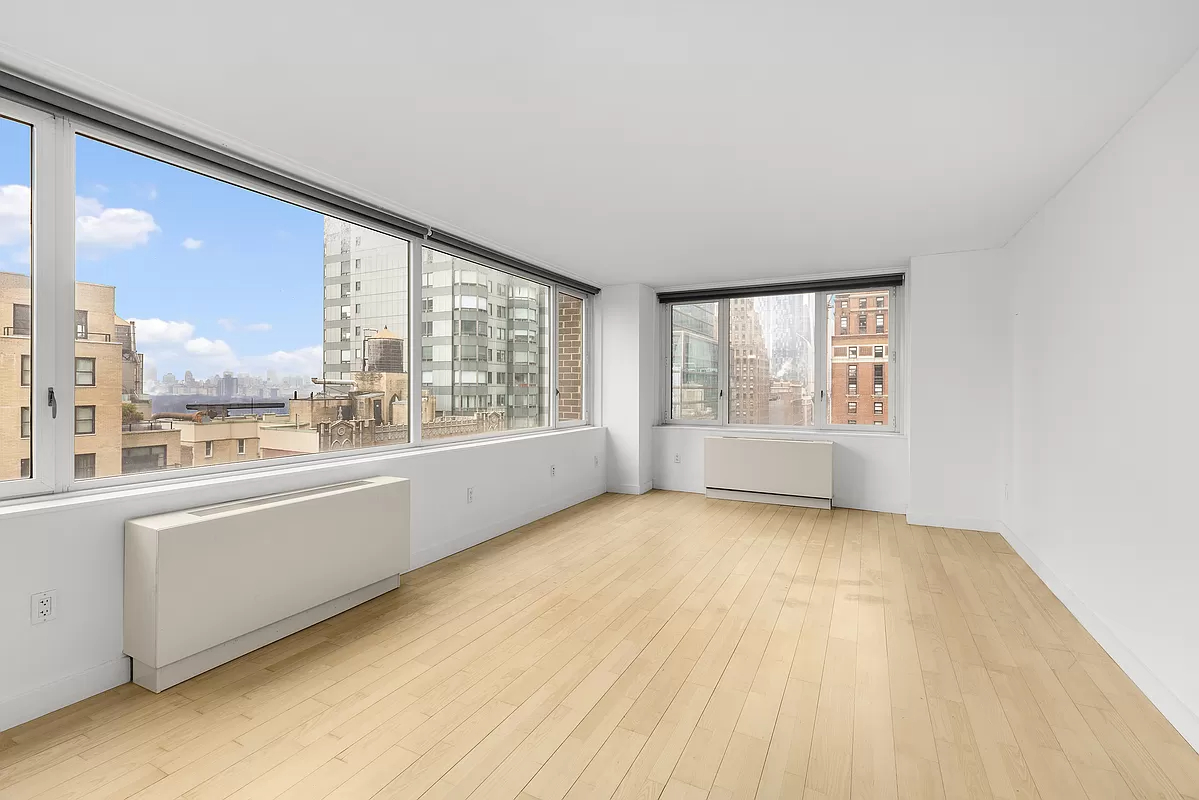322 West 57th Street, Unit 25H Manhattan, NY 10019 - Photo 1 of 9 a view of an empty room with a window