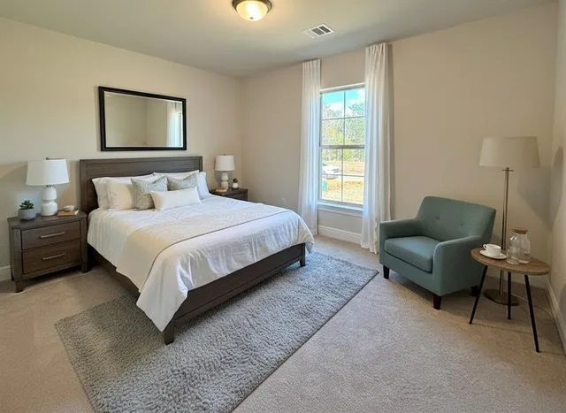 a bedroom with a bed couch and window