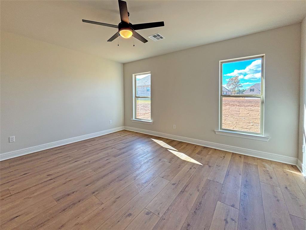 406 Hummingbird Lane Princeton, LA 71067 - Photo 16 of 25 wooden floor in an empty room with a window