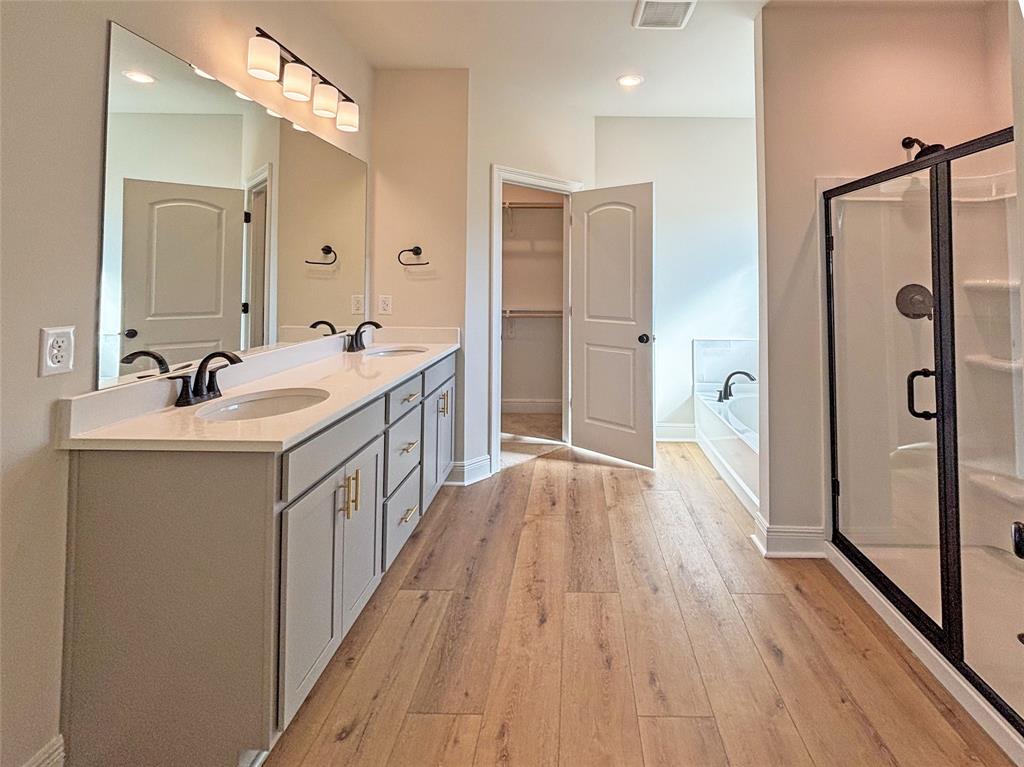 406 Hummingbird Lane Princeton, LA 71067 - Photo 19 of 25 a bathroom with a double vanity sink and mirror