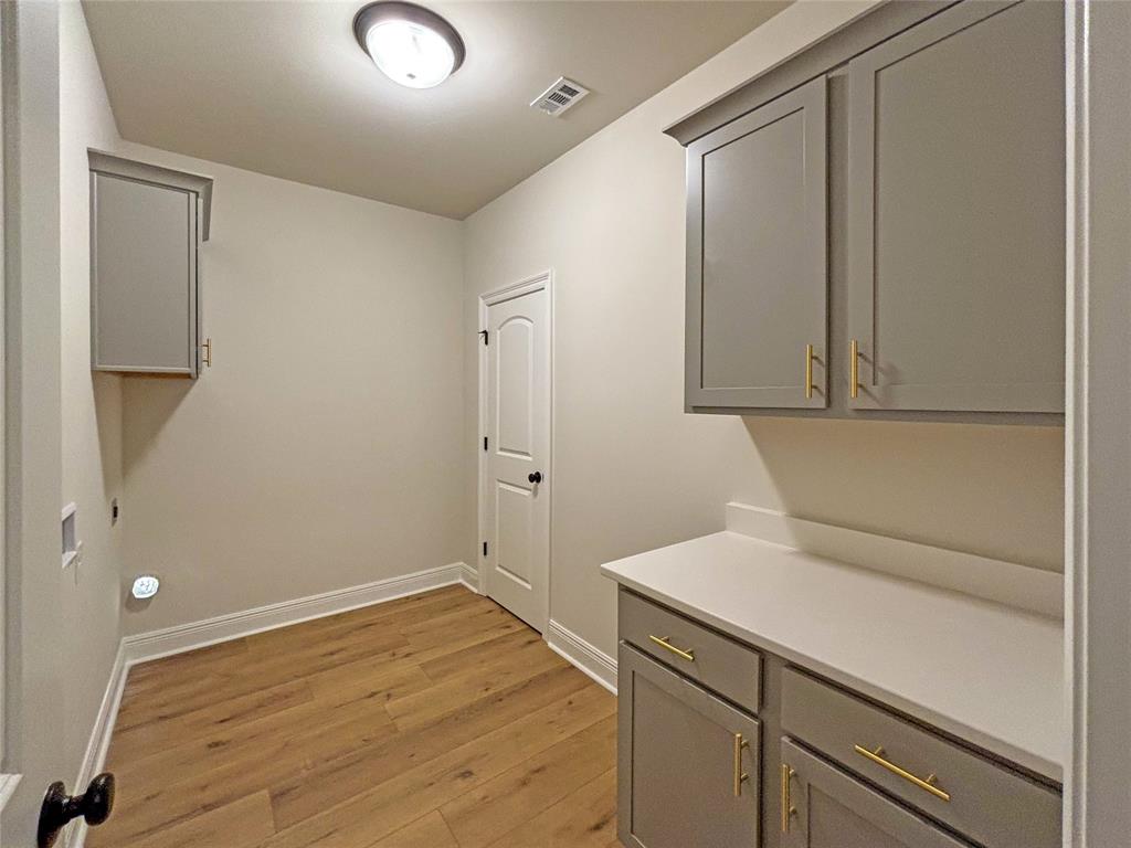 406 Hummingbird Lane Princeton, LA 71067 - Photo 2 of 25 a view of storage and utility room with wooden floor