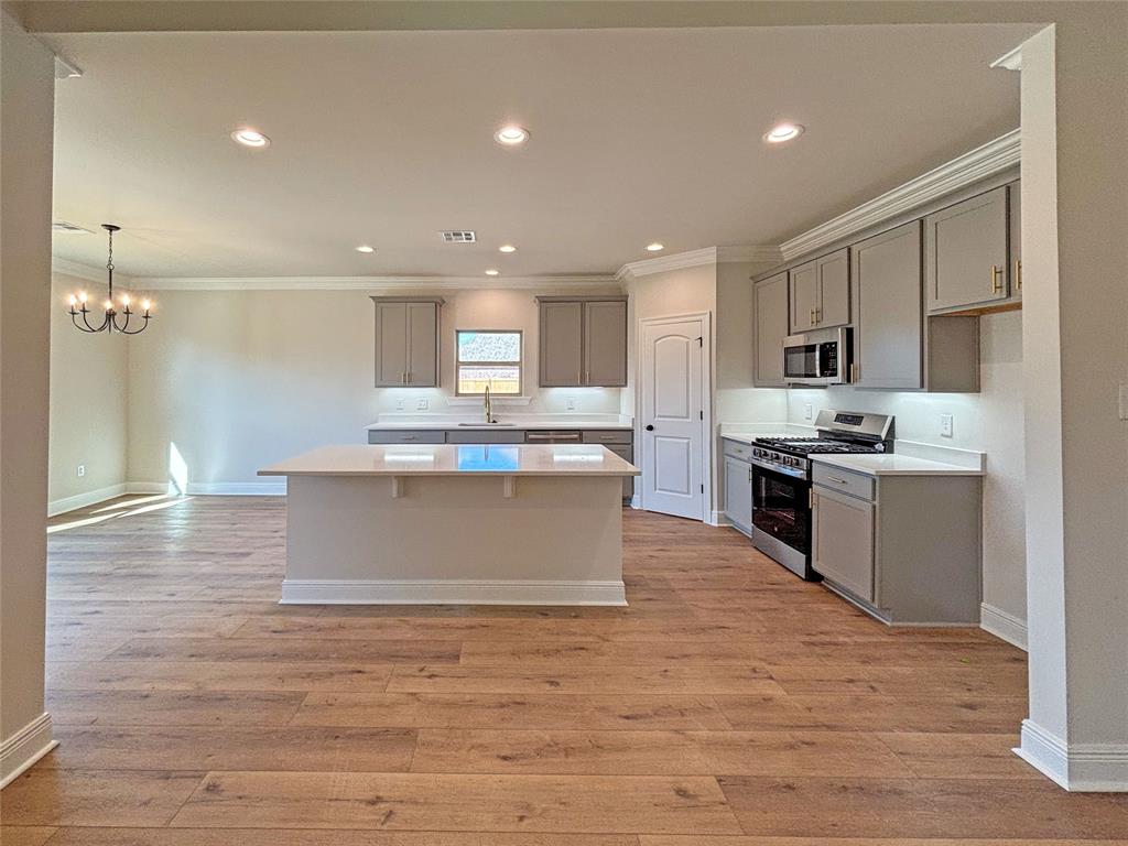 406 Hummingbird Lane Princeton, LA 71067 - Photo 4 of 25 a large kitchen with stainless steel appliances granite countertop a stove a sink dishwasher and a refrigerator