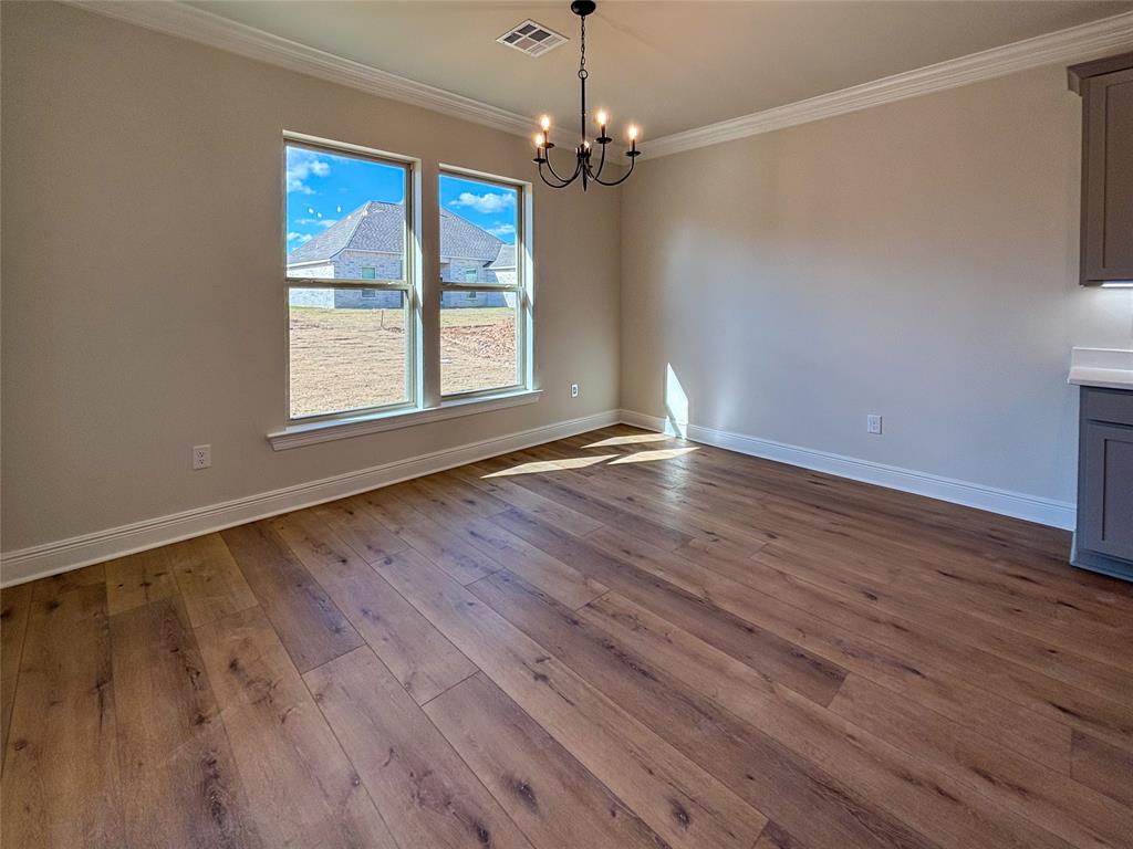 406 Hummingbird Lane Princeton, LA 71067 - Photo 7 of 25 a view of an empty room with wooden floor and a window