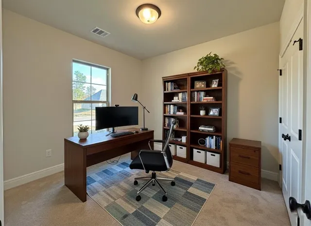 a view of a workspace with furniture