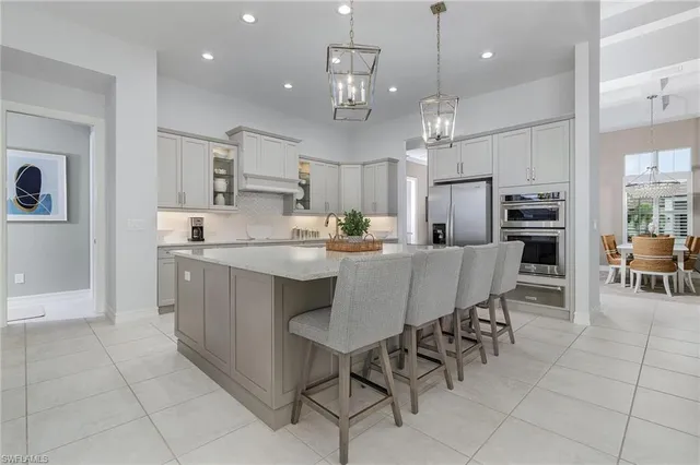 a view of a kitchen with stainless steel appliances granite countertop a sink counter space cabinets and a wooden floor