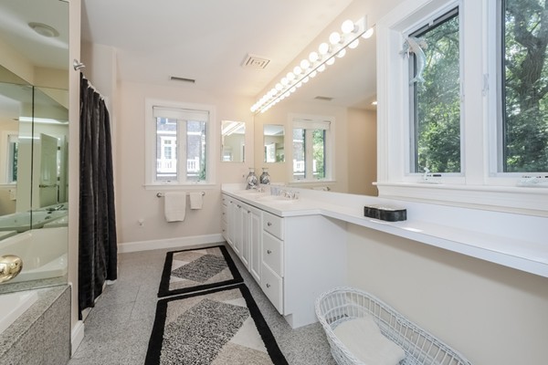 354 Woodland Road Brookline, MA 02467 - Photo 21 of 30 a bathroom with a granite countertop sink mirror vanity and a bathtub