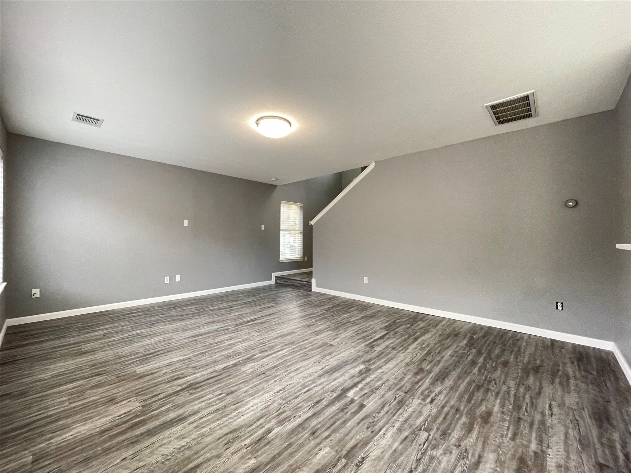 3638 Windhill Loop Round Rock, TX 78681 - Photo 16 of 32 Spacious living area featuring wood-finish flooring, neutral paint, and white trim