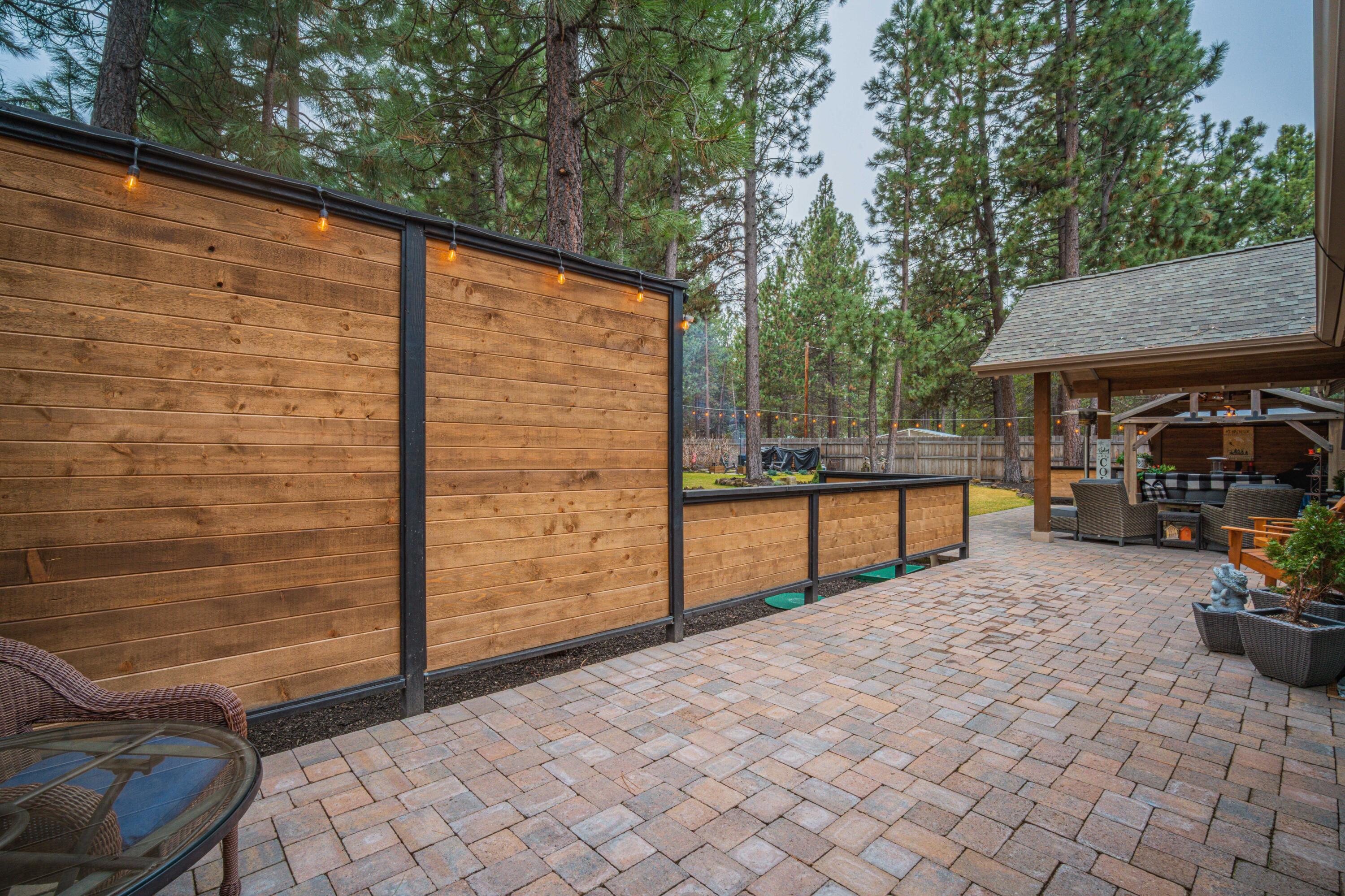 16927 Covina Road Bend, OR 97707 - Photo 31 of 54 Broad patio view showing the covered living area, custom hardscape, and the outdoor pavilion that elevate this backyard into a true oasis.