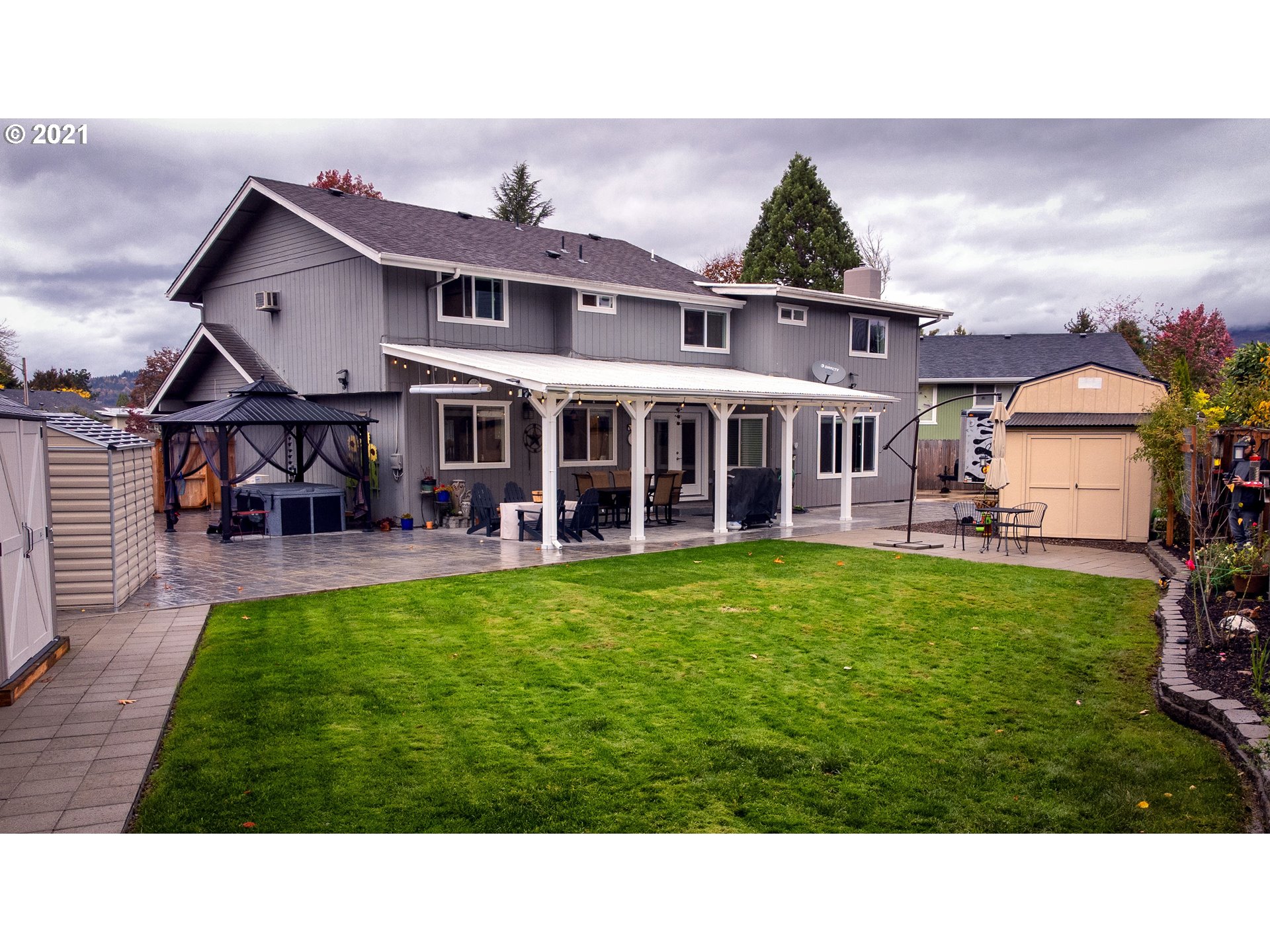 497 71st Street Springfield, OR 97478 - Photo 28 of 32 a view of a house with a backyard porch and sitting area