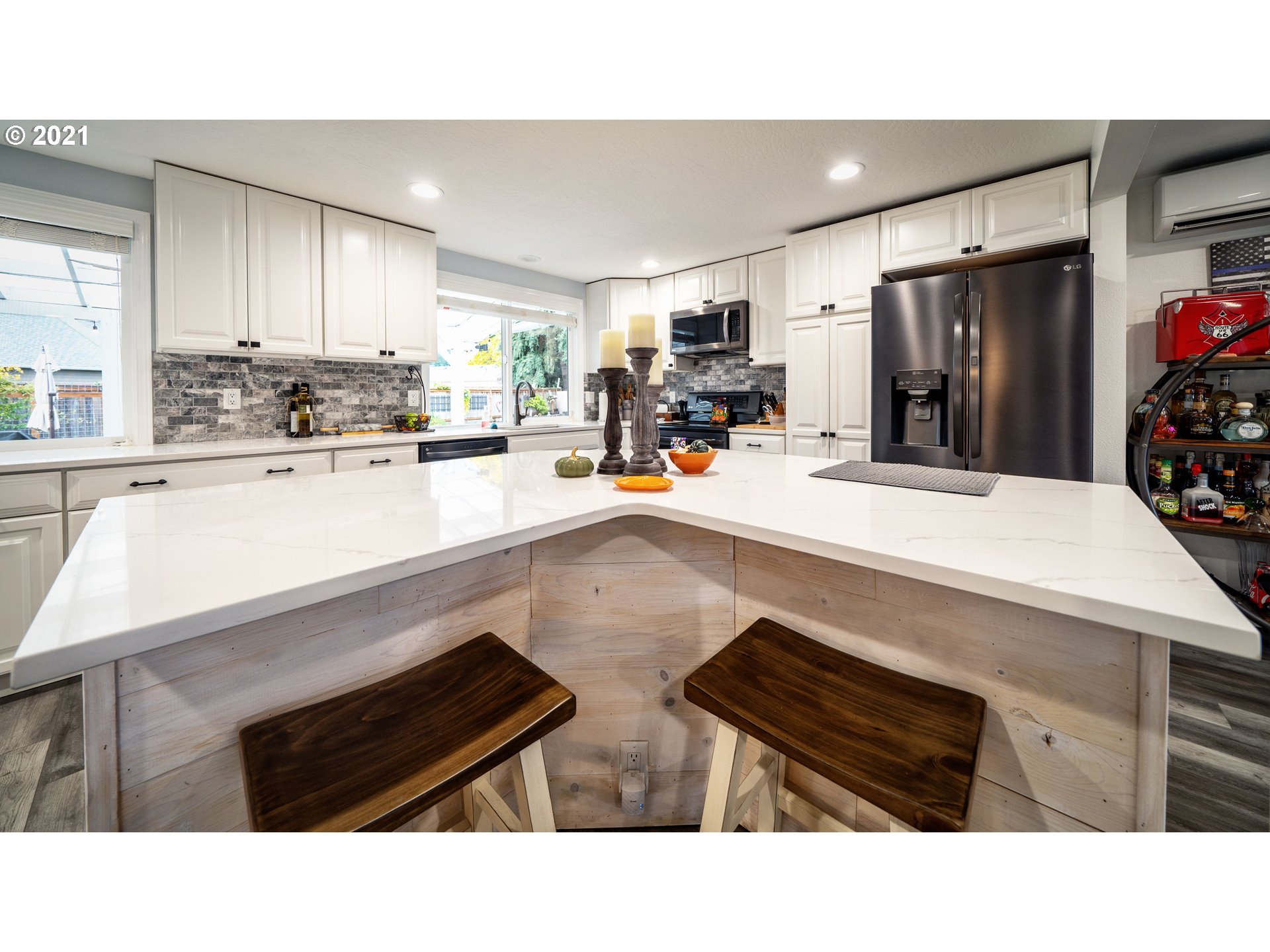 497 71st Street Springfield, OR 97478 - Photo 6 of 32 a kitchen with stainless steel appliances kitchen island granite countertop a sink refrigerator and cabinets