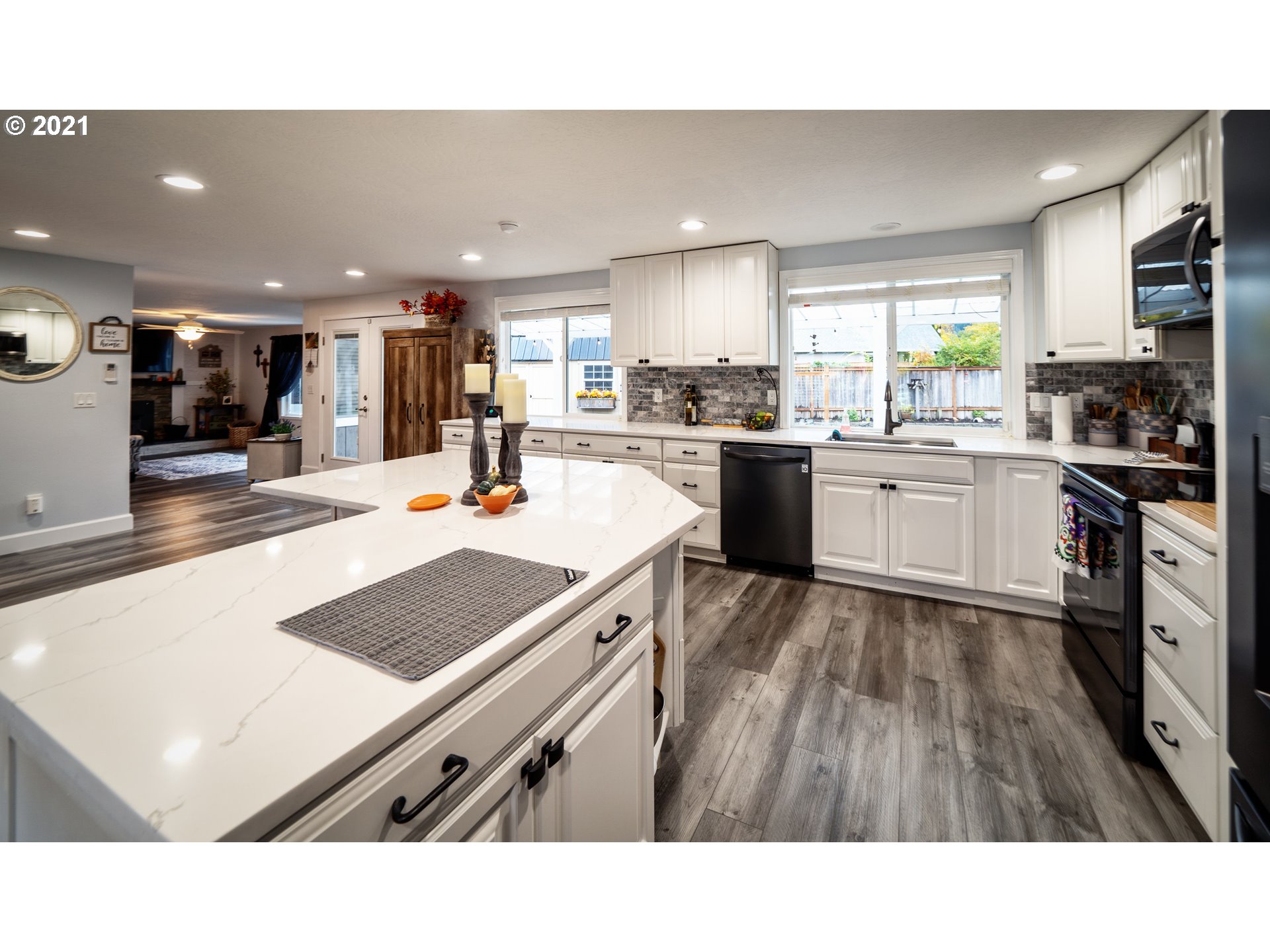 497 71st Street Springfield, OR 97478 - Photo 9 of 32 a kitchen with stainless steel appliances kitchen island granite countertop a sink and cabinets