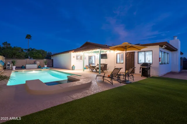 a view of a house with backyard sitting area and garden