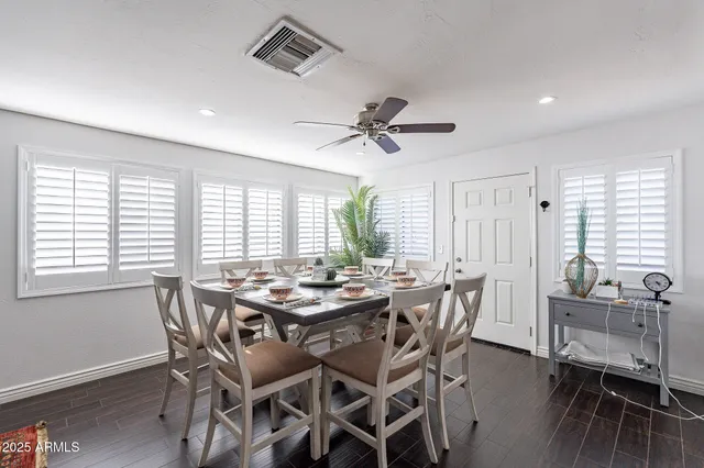 a living room with furniture ceiling fan and a window