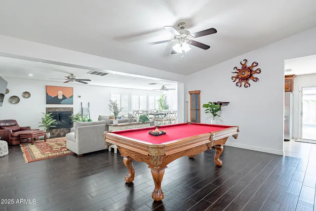 a bedroom with a bed a computer on a desk and chair