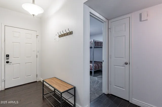 a bedroom with a bed dresser and a flat screen tv