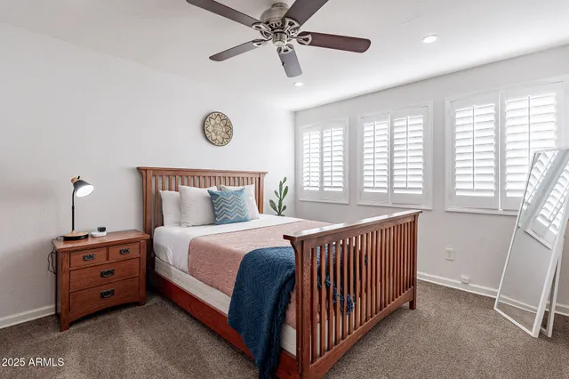 a bathroom with a granite countertop sink a mirror and shower