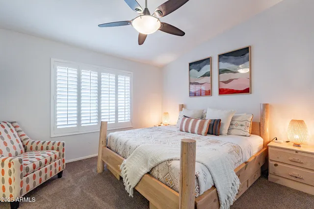 a bedroom with a large bed and a window