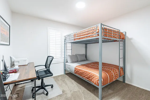 a bathroom with a granite countertop sink mirror vanity and toilet