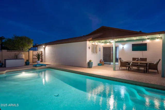 a view of a backyard with furniture and a table
