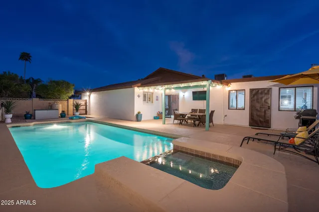 a view of a patio with table and chairs under an umbrella