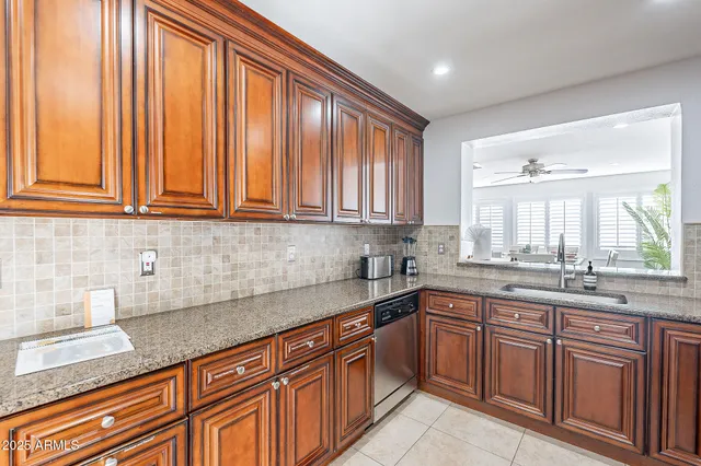 a kitchen with stainless steel appliances granite countertop a stove microwave and refrigerator