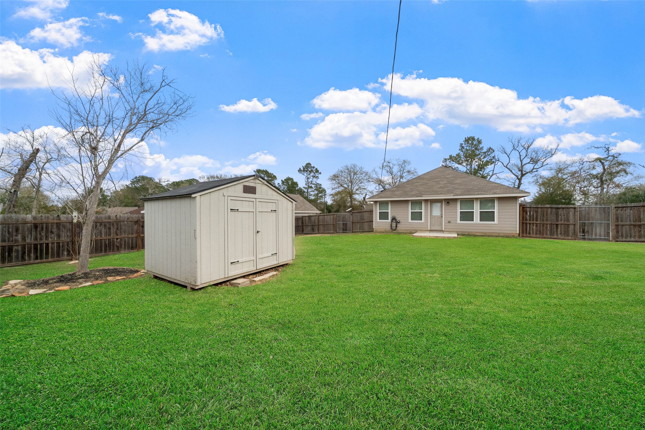 26431 Pin Oak Drive Hempstead, TX 77445 - Photo 22 of 32 Spacious, fully fenced backyard with storage shed and plenty of room for pets, play, or outdoor entertaining. Lawn appearance has been digitally enhanced.