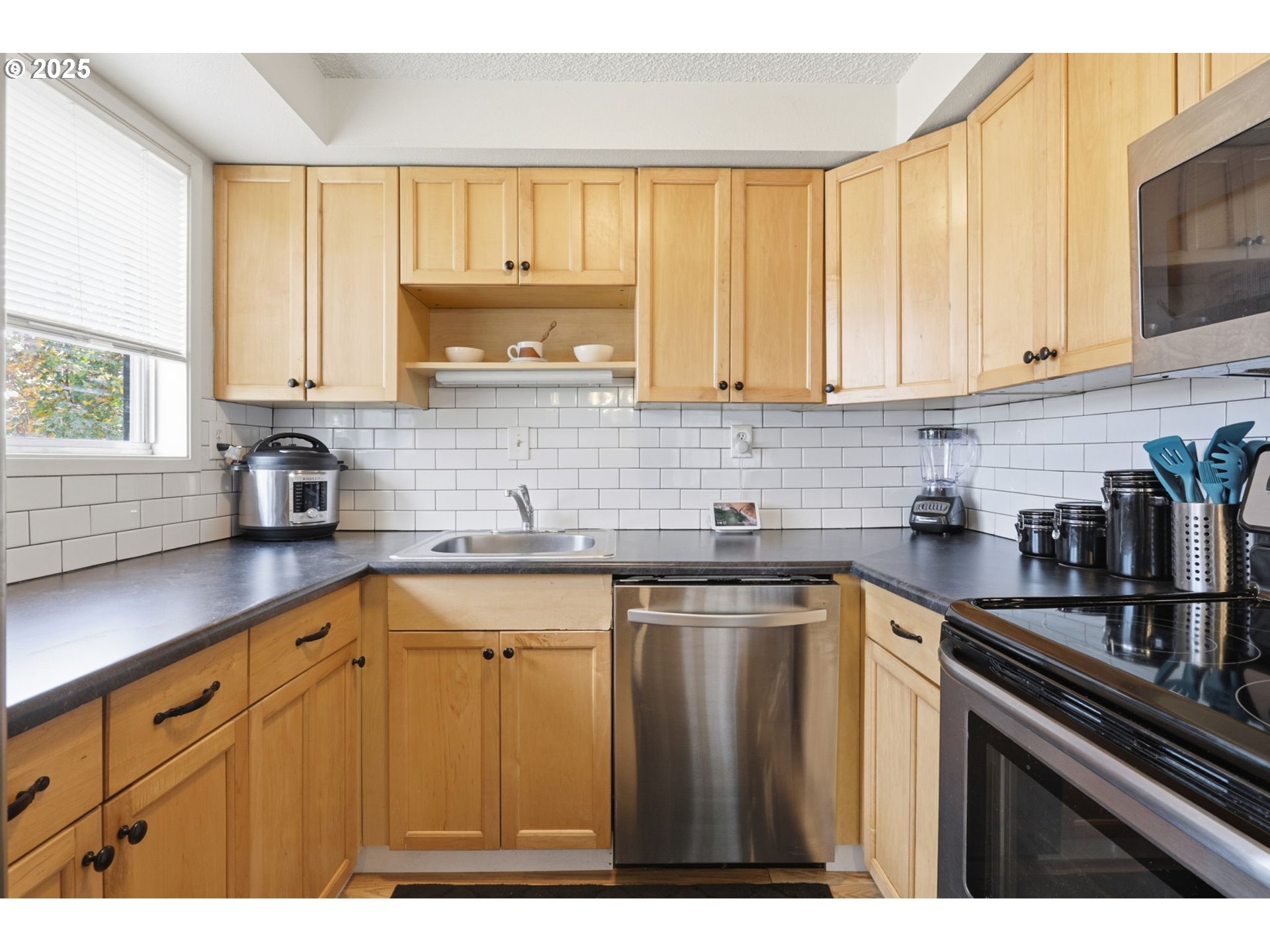 1123 Northwest Ash Street Camas, WA 98607 - Photo 11 of 26 a kitchen with kitchen island granite countertop a sink window and cabinets