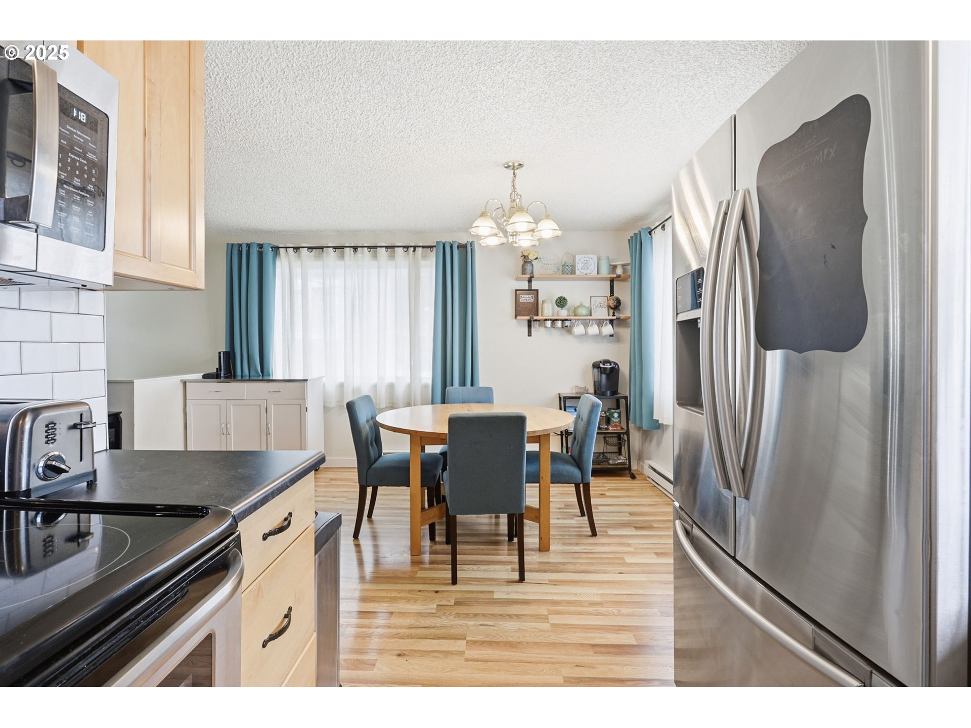 1123 Northwest Ash Street Camas, WA 98607 - Photo 12 of 26 a kitchen with stainless steel appliances granite countertop a refrigerator a sink a stove and a refrigerator